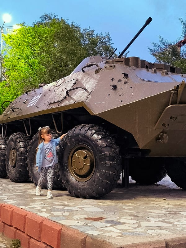 Military vehicle on public display in Qarağandı at sunset