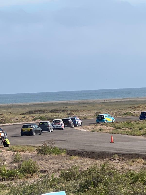 Race day at Arica's coastal track, cars and flags everywhere