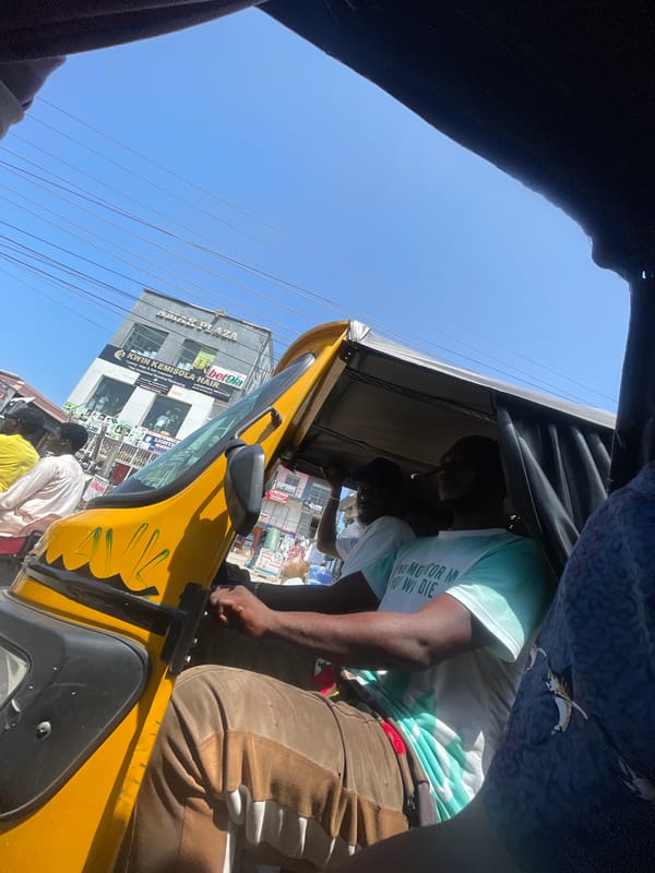 Passenger view from yellow auto-rickshaw captured in Ado, Nigeria