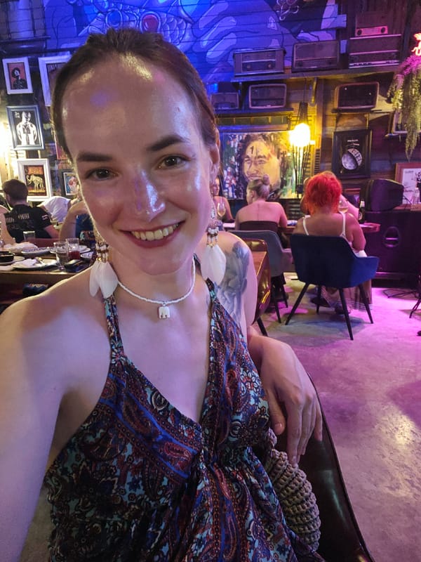 Inside and outside a dimly lit Phuket bar or restaurant