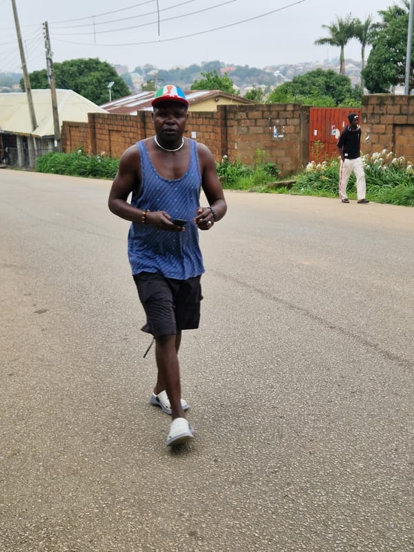 Morning street activity in a busy West African urban neighborhood