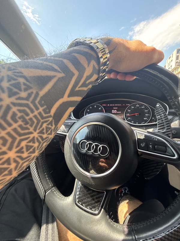 Tattooed driver operates Audi in Sofia morning commute