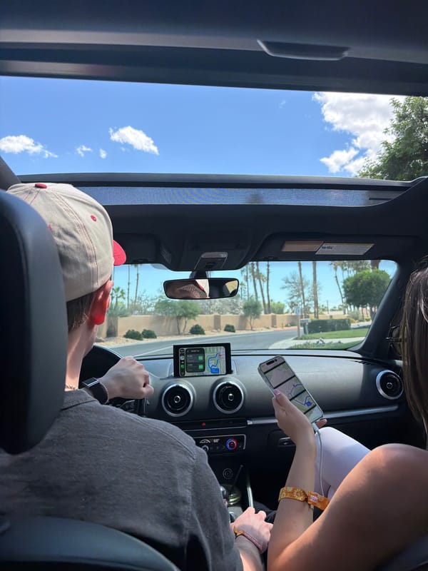 Driver in baseball cap spotted on palm-lined La Quinta street