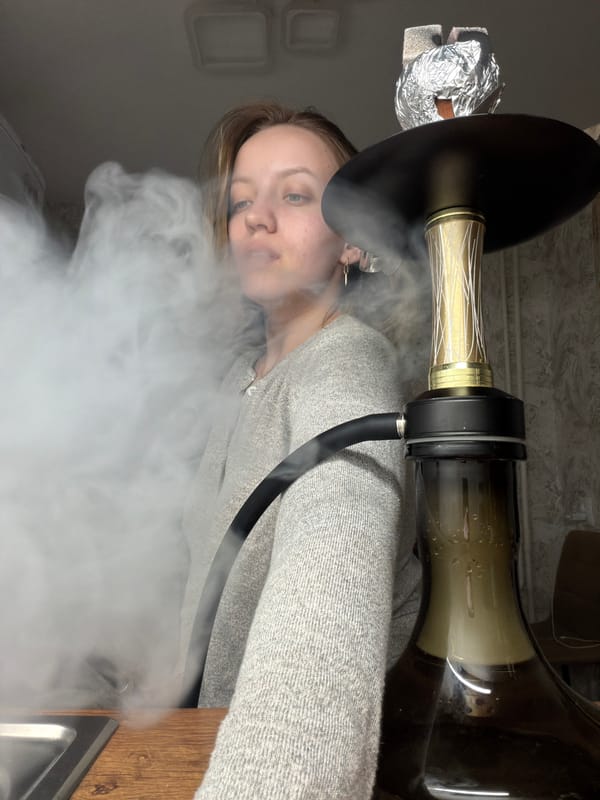 Woman smoking hookah indoors captured in Reshetnikovo, Russia