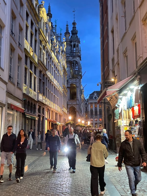 Evening crowds gather at illuminated Brussels Grand Place