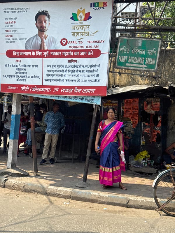 Motorcyclist spotted on Kolkata street near religious event banner