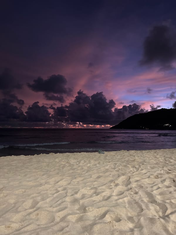 Rawai Beach at golden hour: crowds, stormy skies, good vibes