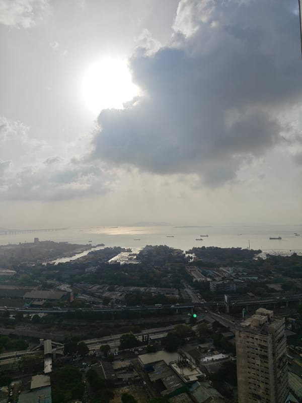 Aerial view captures cloudy Mumbai cityscape with Arabian Sea