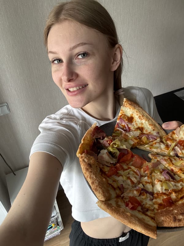 Woman documents morning routine and pizza breakfast in Perm