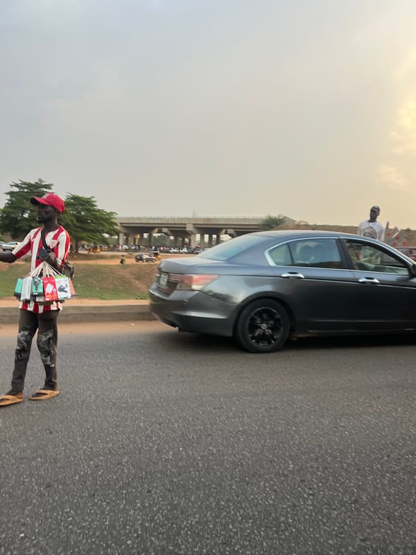 Street vendor sells items roadside near Galadimawa Village, Nigeria
