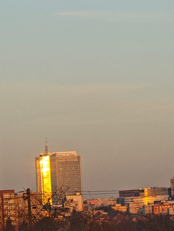 Prague cityscape captured at sunrise with golden reflections