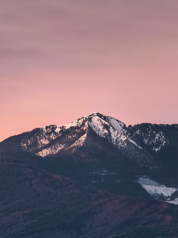 Snow-capped mountains observed under pink sky in Mikrevo, Bulgaria