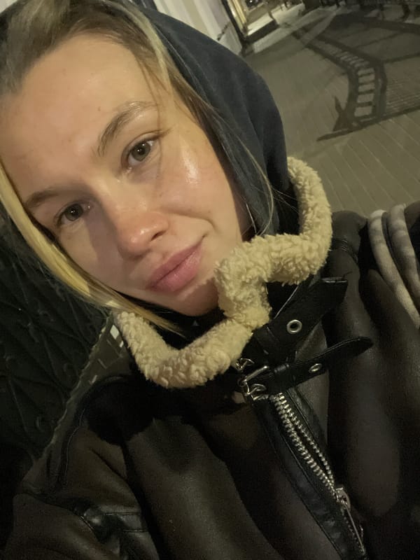 Woman takes nighttime selfies on illuminated Voronezh street