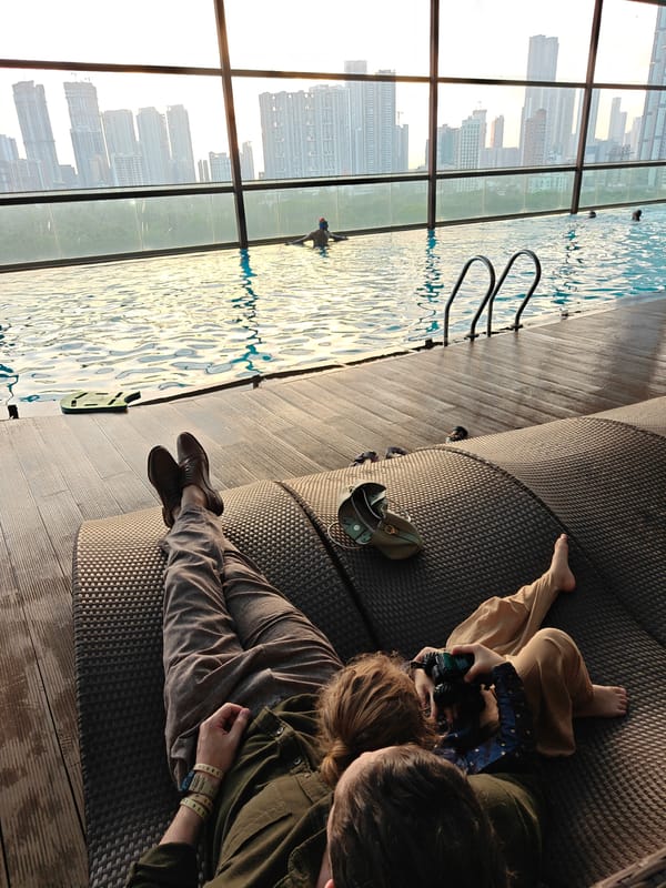Family relaxes at Mumbai hotel rooftop pool during afternoon