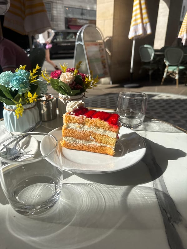 Layered cream and jam cake at a London café table
