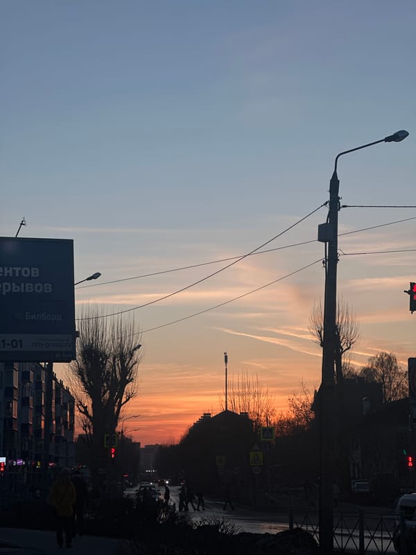 Sunset street scene captured in Kazan with contrails overhead