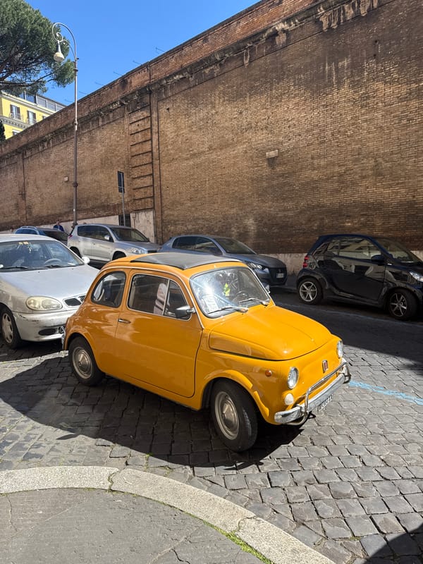 Routine street scene documented in Rome with parked cars