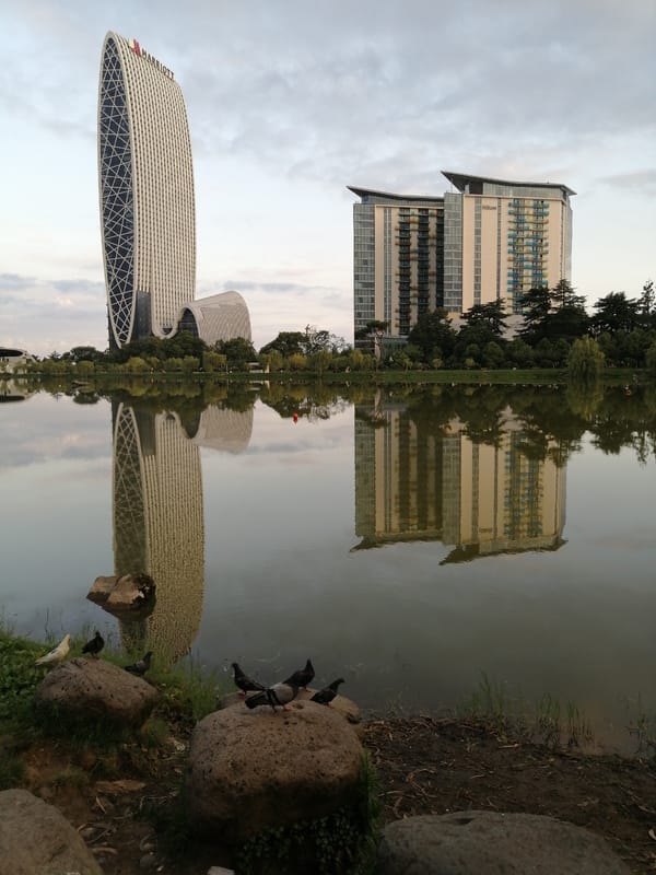 Batumi's landmark waterfront hotels reflected in still water