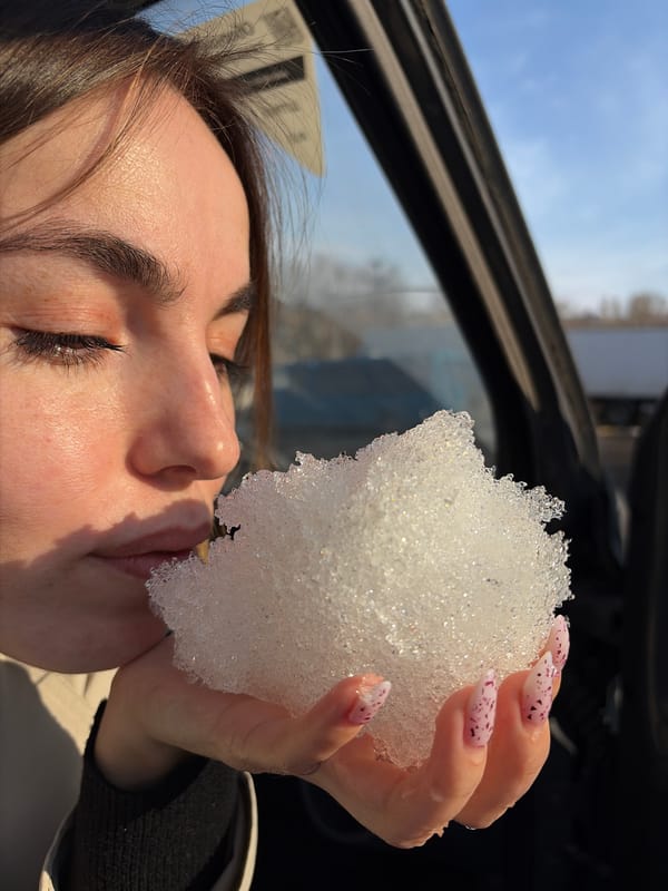 Woman eating snow captured in multiple moments in Izhevsk