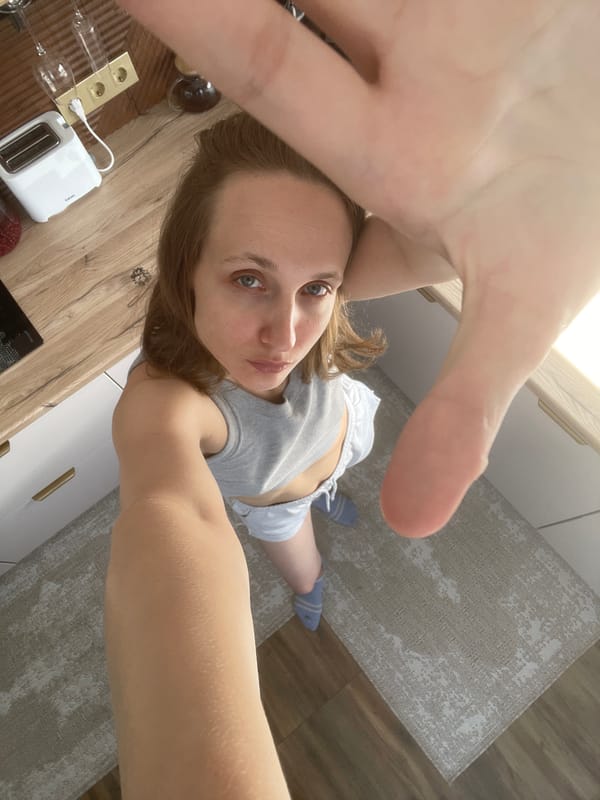 Woman Takes Kitchen Selfies in Gray Tank Top