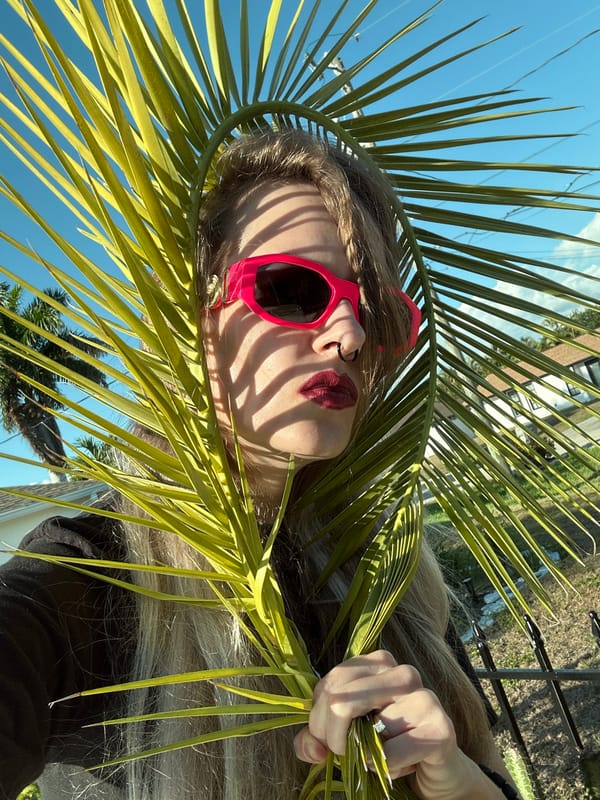 Woman poses with palm frond in Cape Coral Friday evening