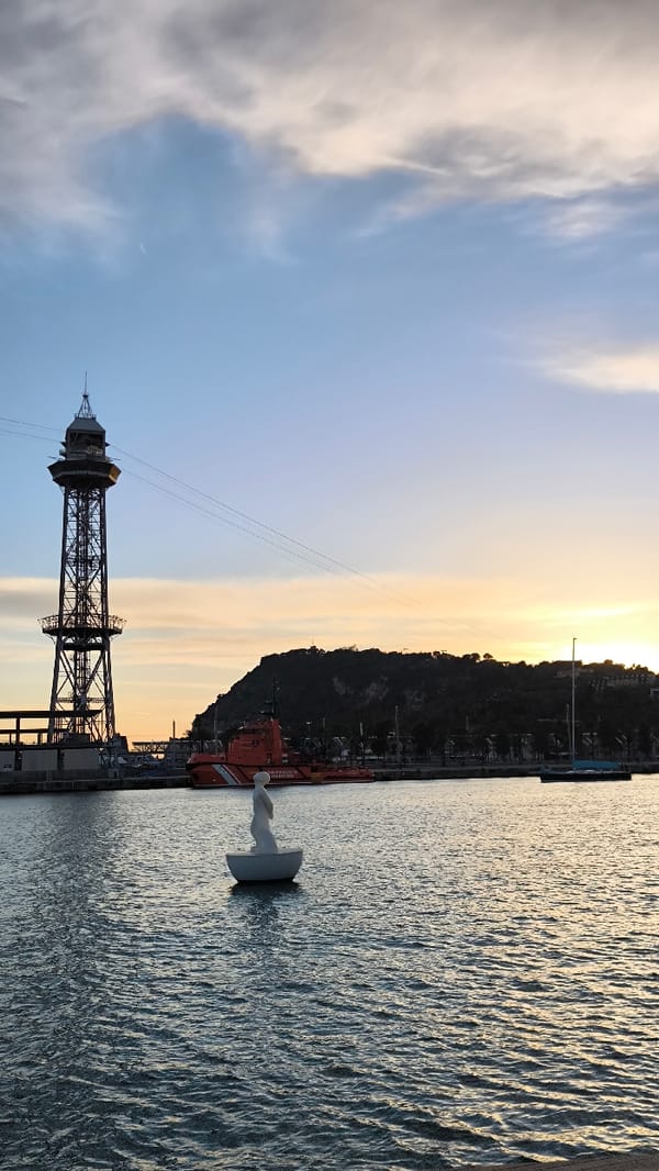 Barcelona harbor evening captures boats, pedestrians, typical waterfront activity