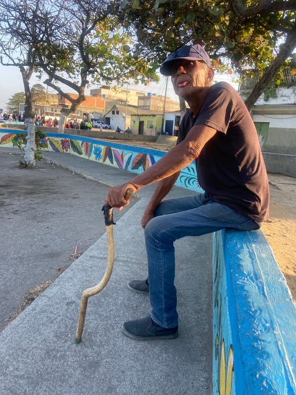 Elderly man observed at decorated waterfront in Higuerote, Venezuela