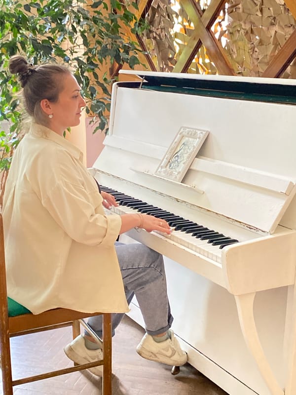 Woman plays piano, takes selfie in Марковский, Russia