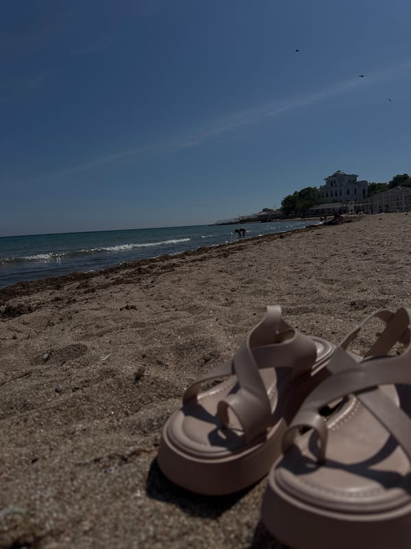 Woman enjoys quiet beach moment in Yevpatoriya, Ukraine