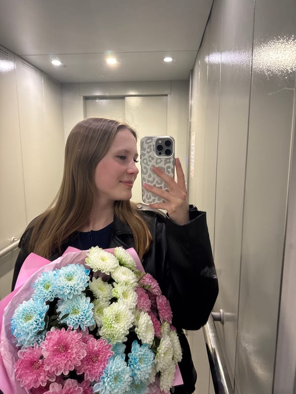 Woman takes flower bouquet selfie in Chaikovsky elevator
