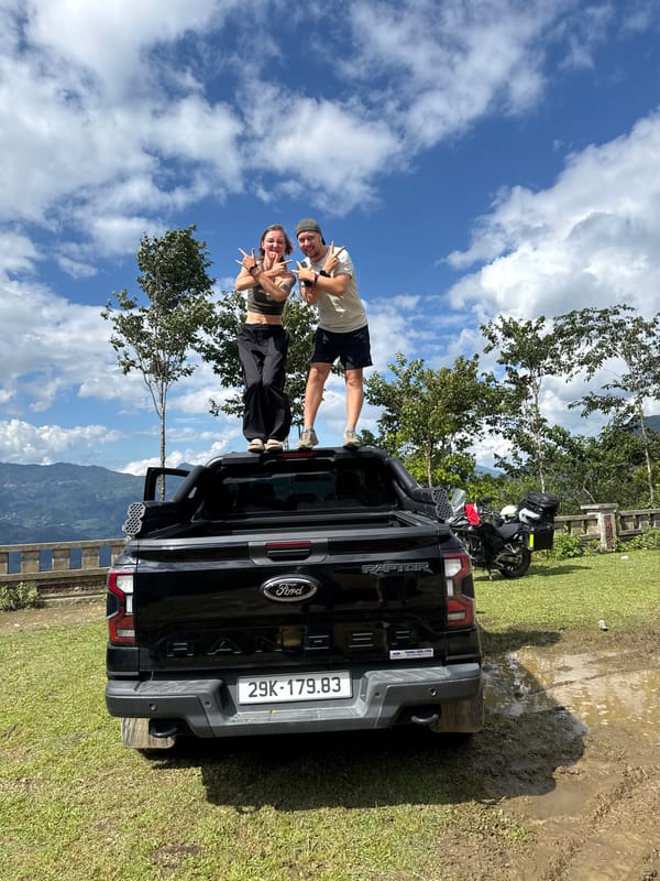 Couple poses on pickup truck at Tu Le scenic overlook