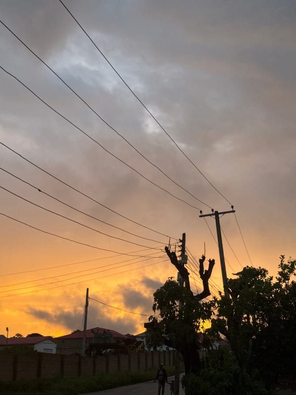Vivid sunset breaks through dark clouds over a residential neighborhood