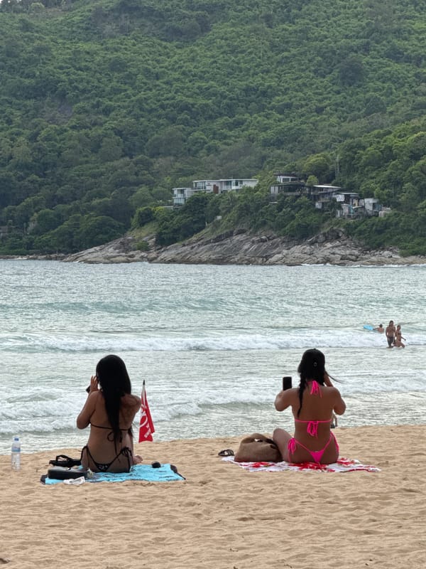 Rawai Beach morning: kitesurfing, sunbathers, and everyday shoreline life