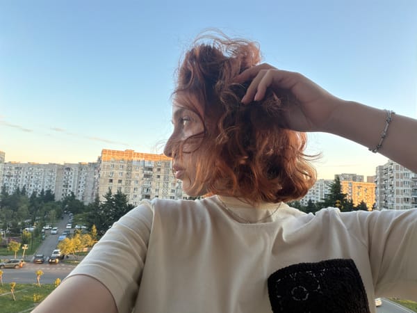 Red-haired woman explores Tbilisi during afternoon documentation session