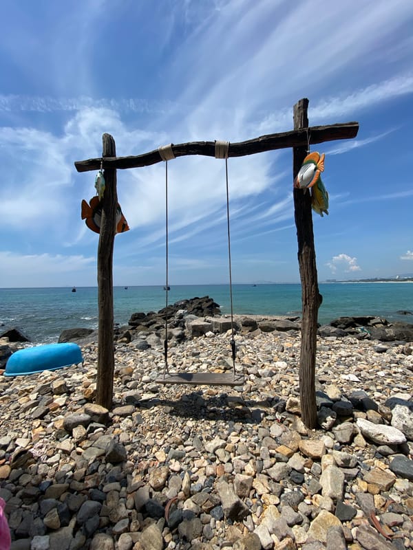 Wooden fish swing on a quiet beach in Cam Lam