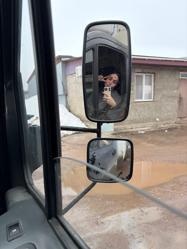Woman photographed in vehicle cab during early morning in Izhevsk
