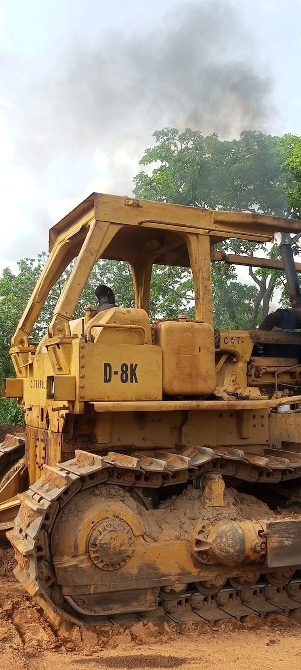 Bulldozer operates on muddy terrain in Otunade, Nigeria