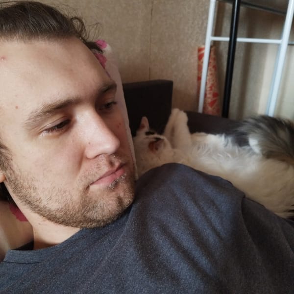 Man photographed reclining indoors in casual portrait