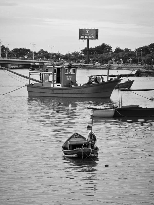 Cai River harbor life, Nha Trang — boats and bridges
