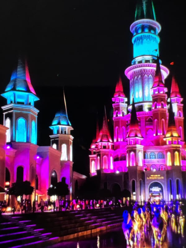 Ornate castle-style building, day and night