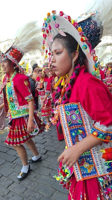 Traditional parade celebrates in Arequipa's historic center with dancers, floats