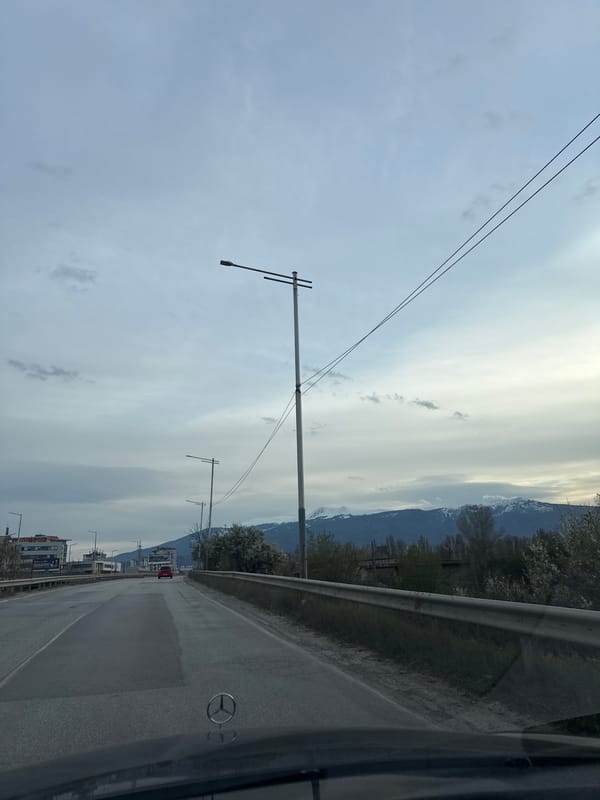 Vehicle travels paved road with guardrails outside Sofia