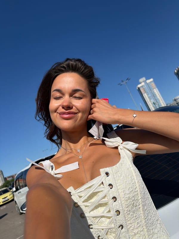 Woman takes selfie in white corset top in Krasnoyarsk