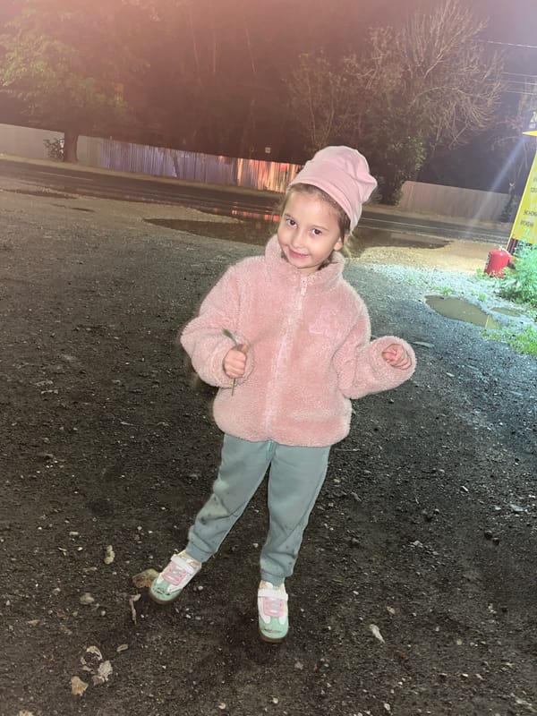 Children play outside during evening rain in Novokuybyshevsk
