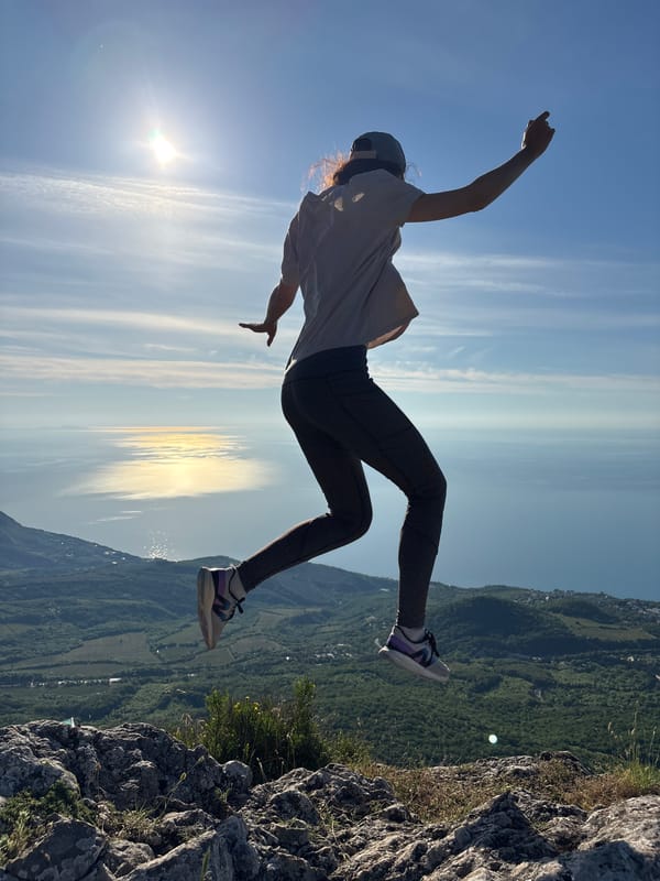 Person jumps at sunrise over Ukrainian coastal landscape