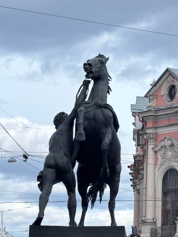 Equestrian statue photographed against cloudy sky in Saint Petersburg