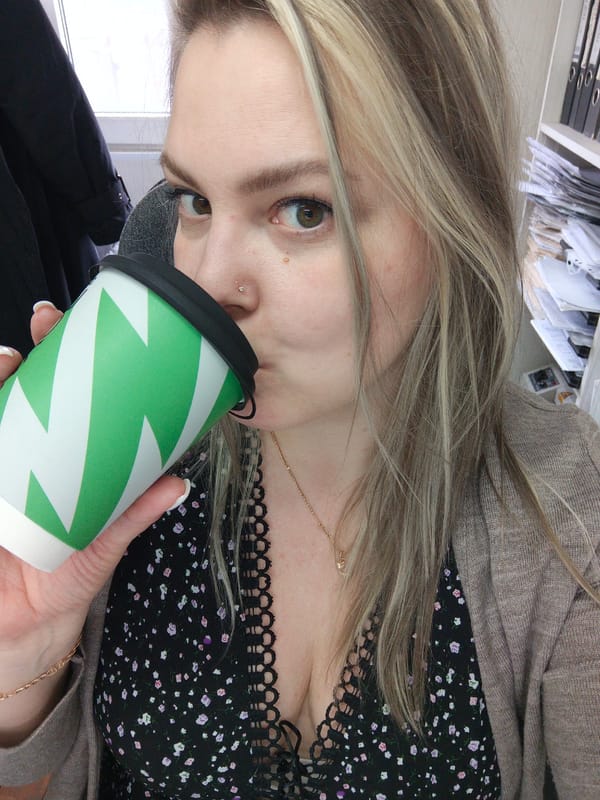 Woman drinks coffee, dog spotted in Noviy Russia morning