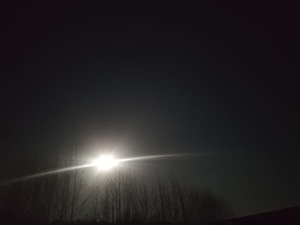 Bright moon dominates night sky over Chaikovsky, Russia
