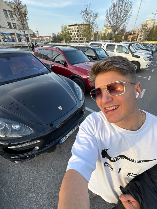 Man poses with luxury cars in Plovdiv parking area