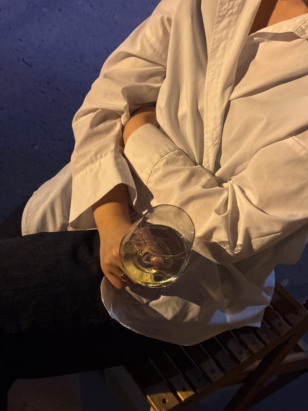 Person enjoys wine outdoors in Belgrade's Vracar district
